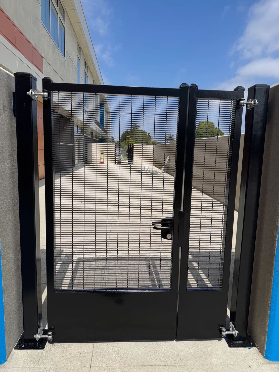 Finished black pedestrian gate with wire infill and locking hardware