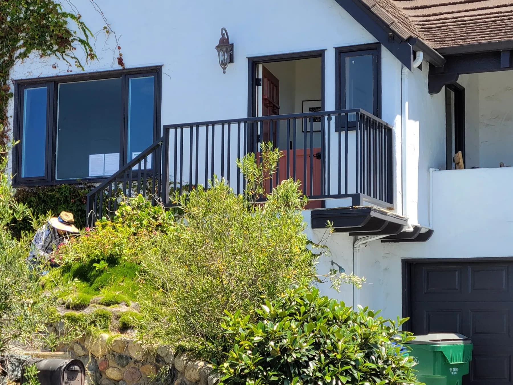Black vertical-picket railing around a raised porch and exterior stairs