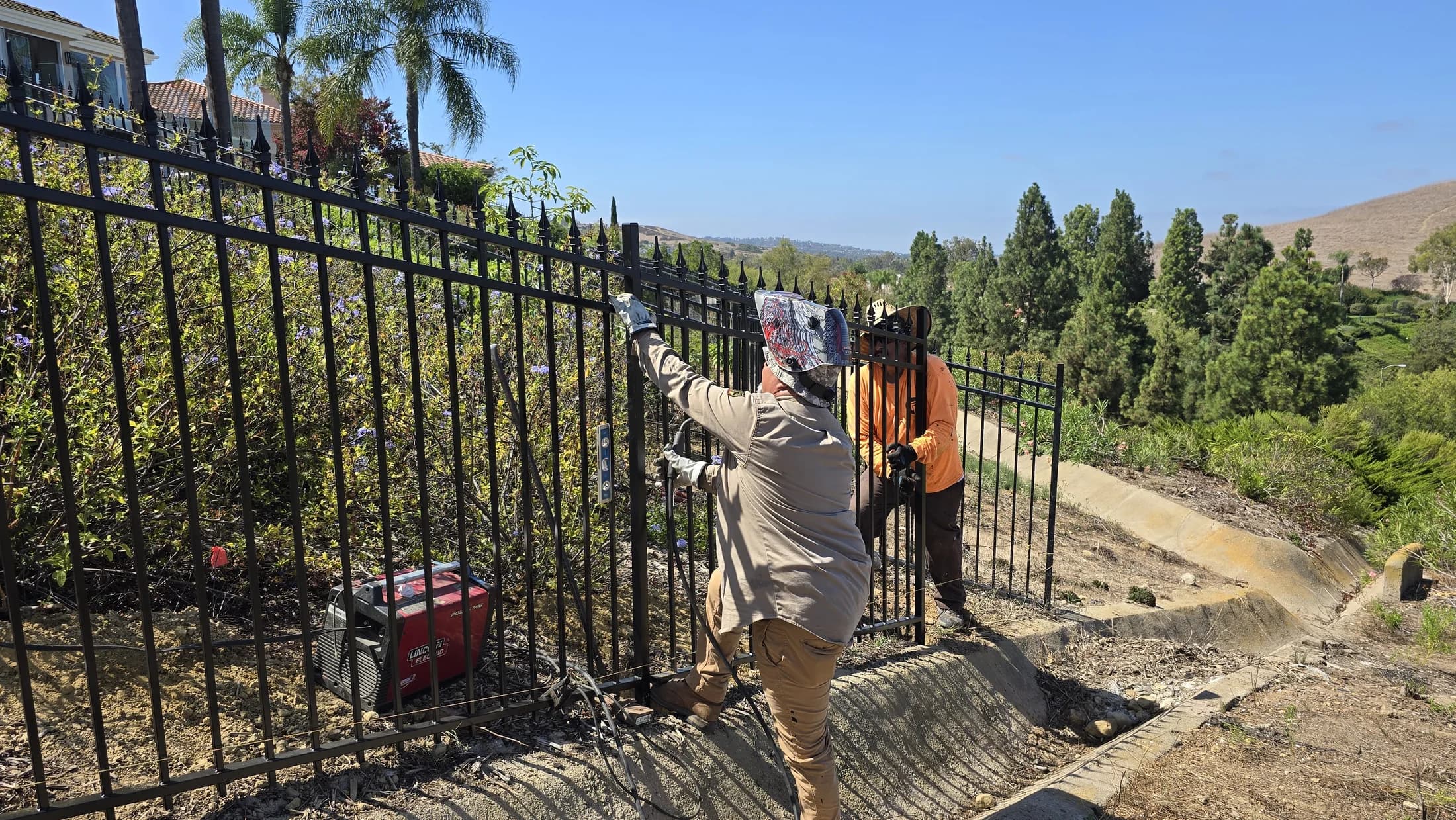 Fence Menders crew repairing perimeter iron at Turtle Rock Summit